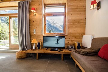 A living room with a flat screen tv and a couch