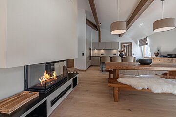 A living room with a fireplace and a wooden table