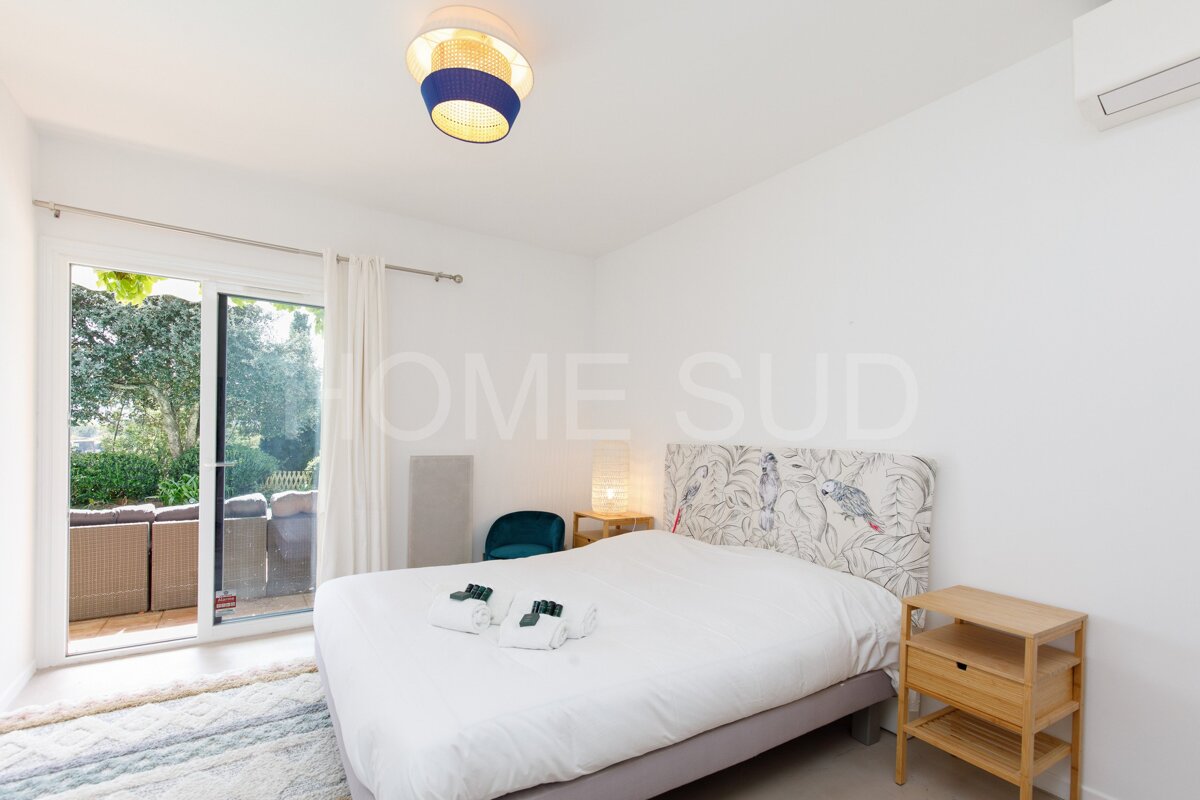 A bedroom with a bed and a sliding glass door that says home sud