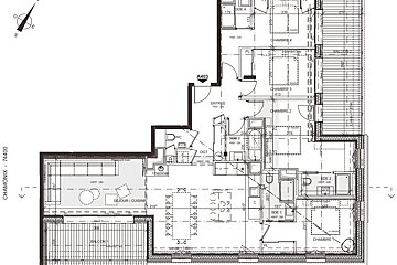 A black and white floor plan of a house with a compass pointing to the north