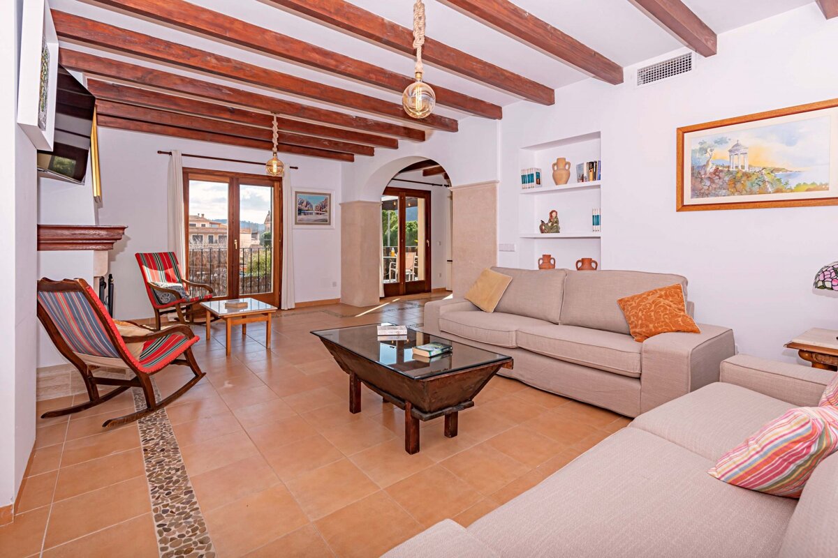 A living room with a couch and two rocking chairs
