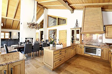 A kitchen with wooden cabinets and granite counter tops