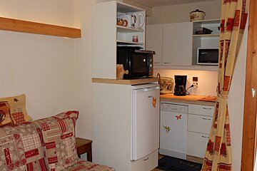 A small kitchen with a dishwasher and a microwave