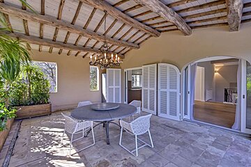 A room with a table and chairs and a chandelier