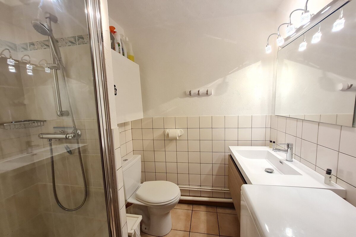 A bathroom with a toilet a sink and a shower
