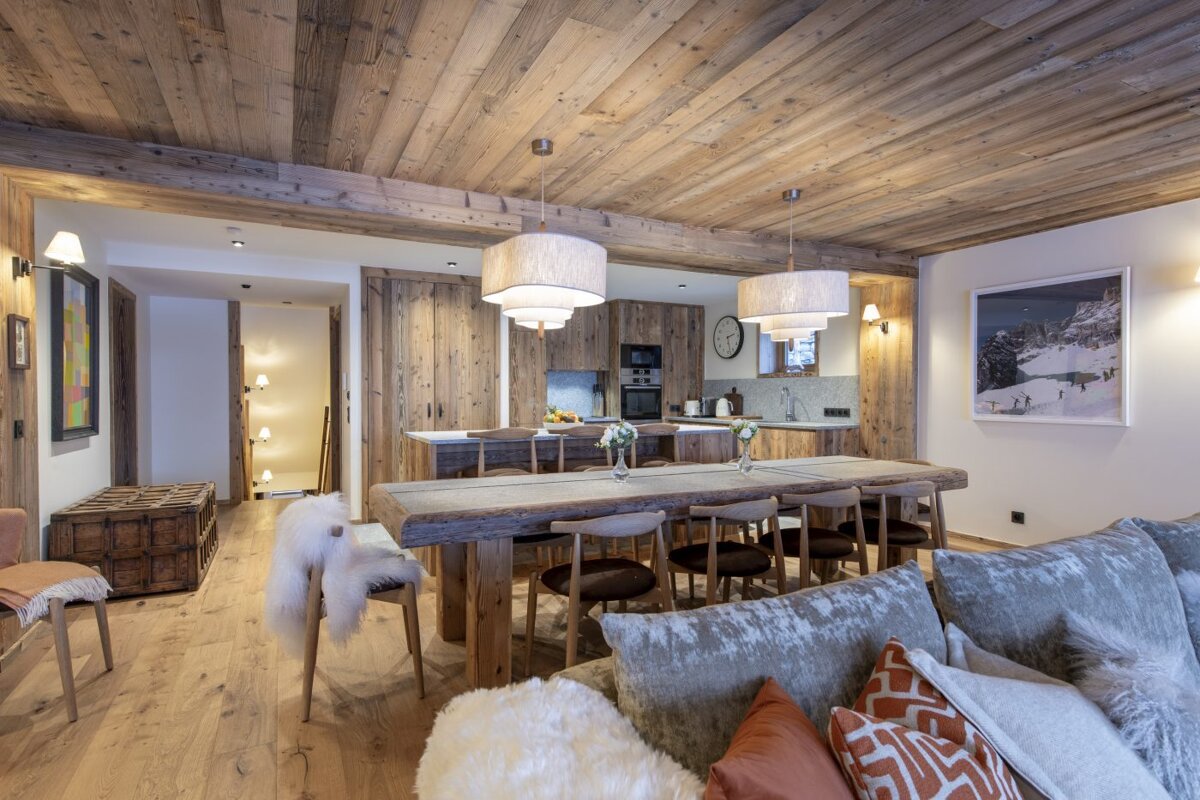 A living room with a wooden table and chairs