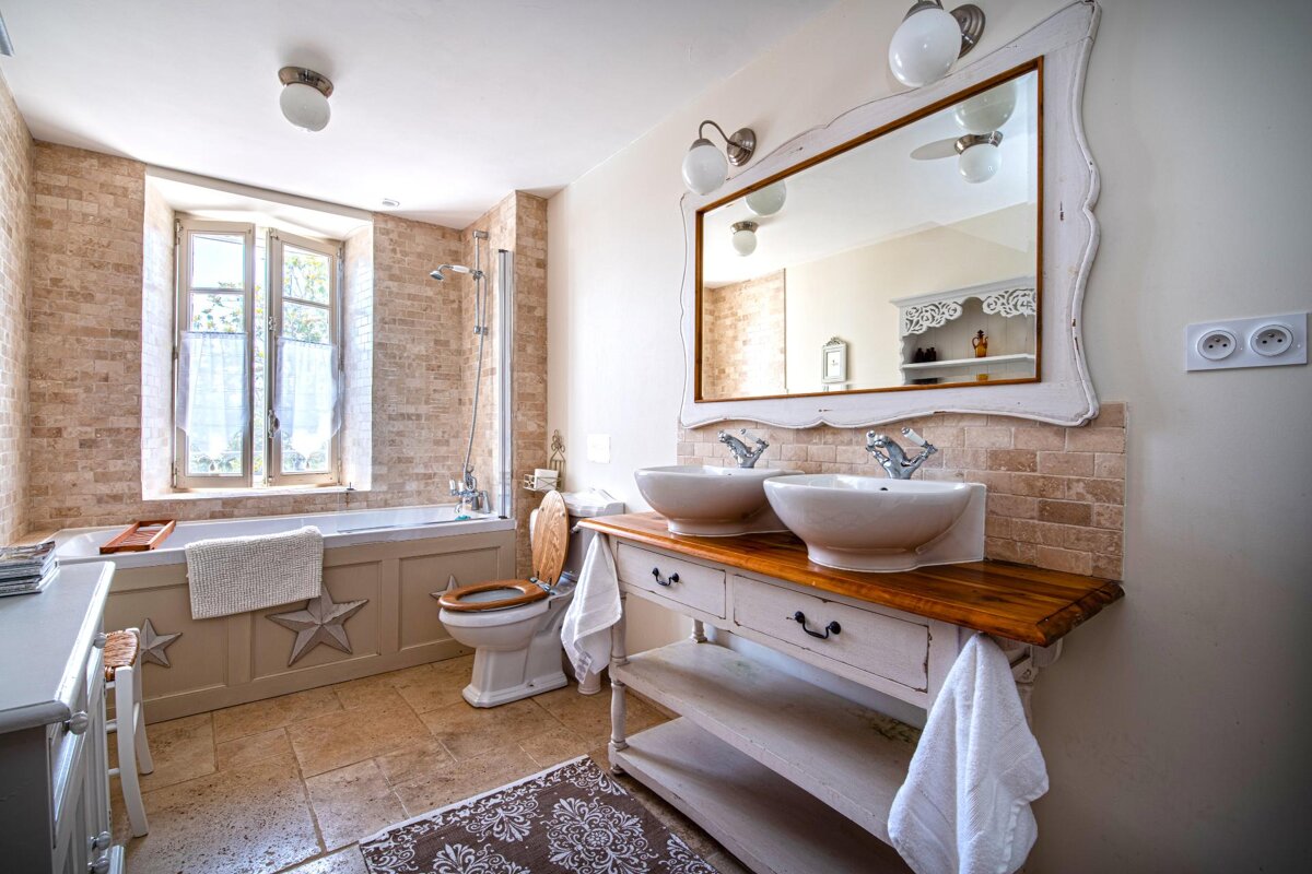 A bathroom with two sinks and a mirror