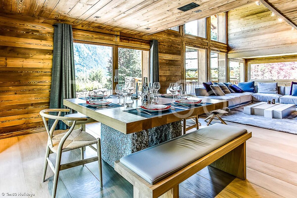 A dining room table with plates and glasses on it
