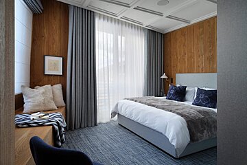 A bedroom with a large bed and a window