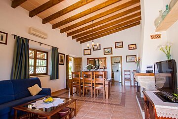 A living room with a blue couch and a television