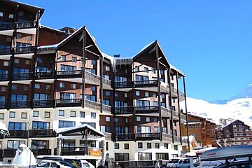 A large building with a lot of windows and balconies