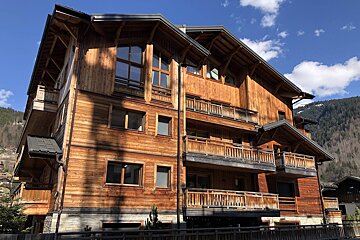 A large wooden building with many windows and balconies