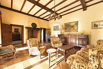 A living room with furniture and a painting on the wall