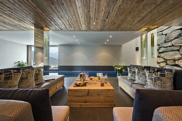 A living room with a wooden table and a couch
