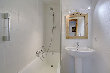 A bathroom with a sink and a bathtub