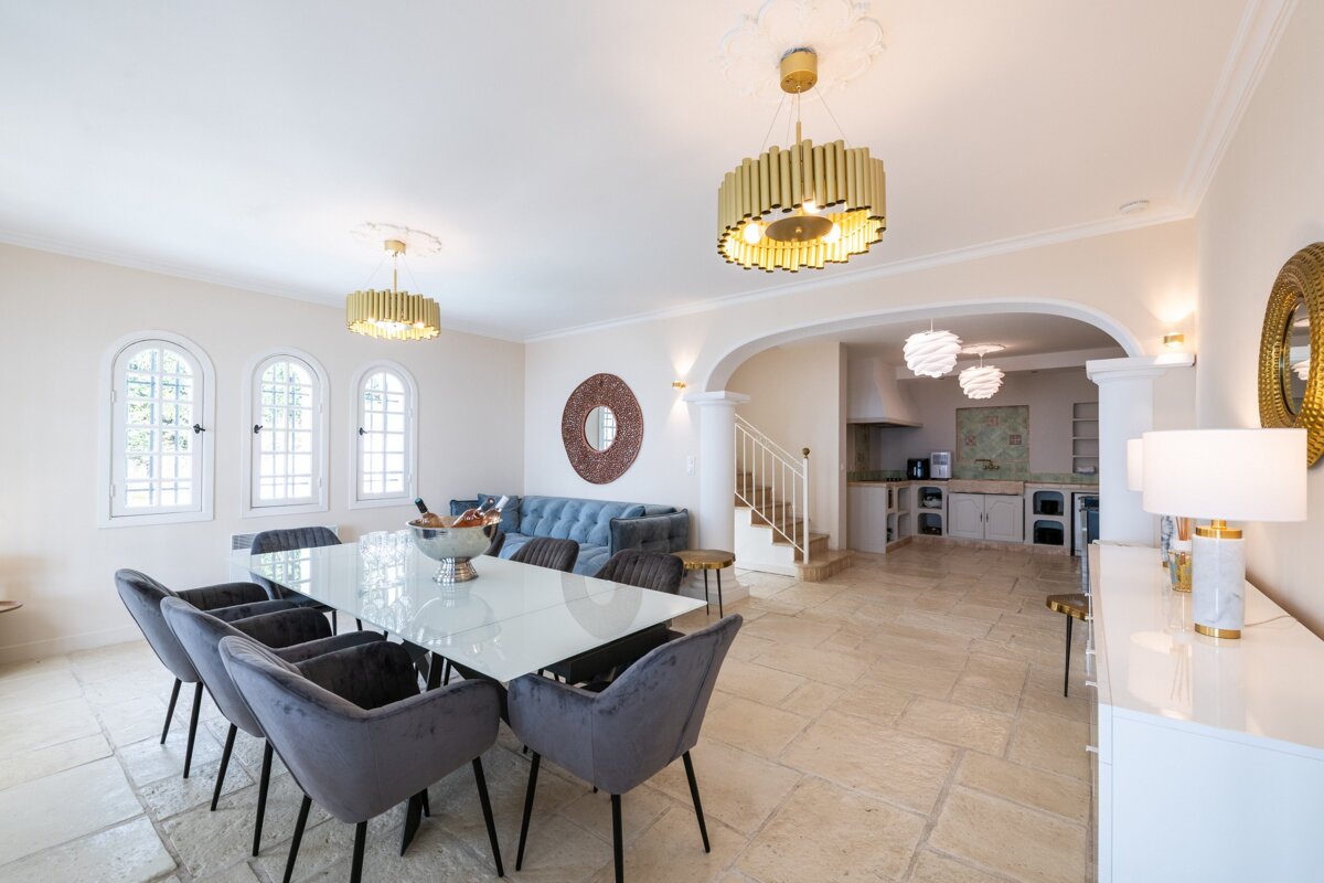 A dining room with a table and chairs and a couch