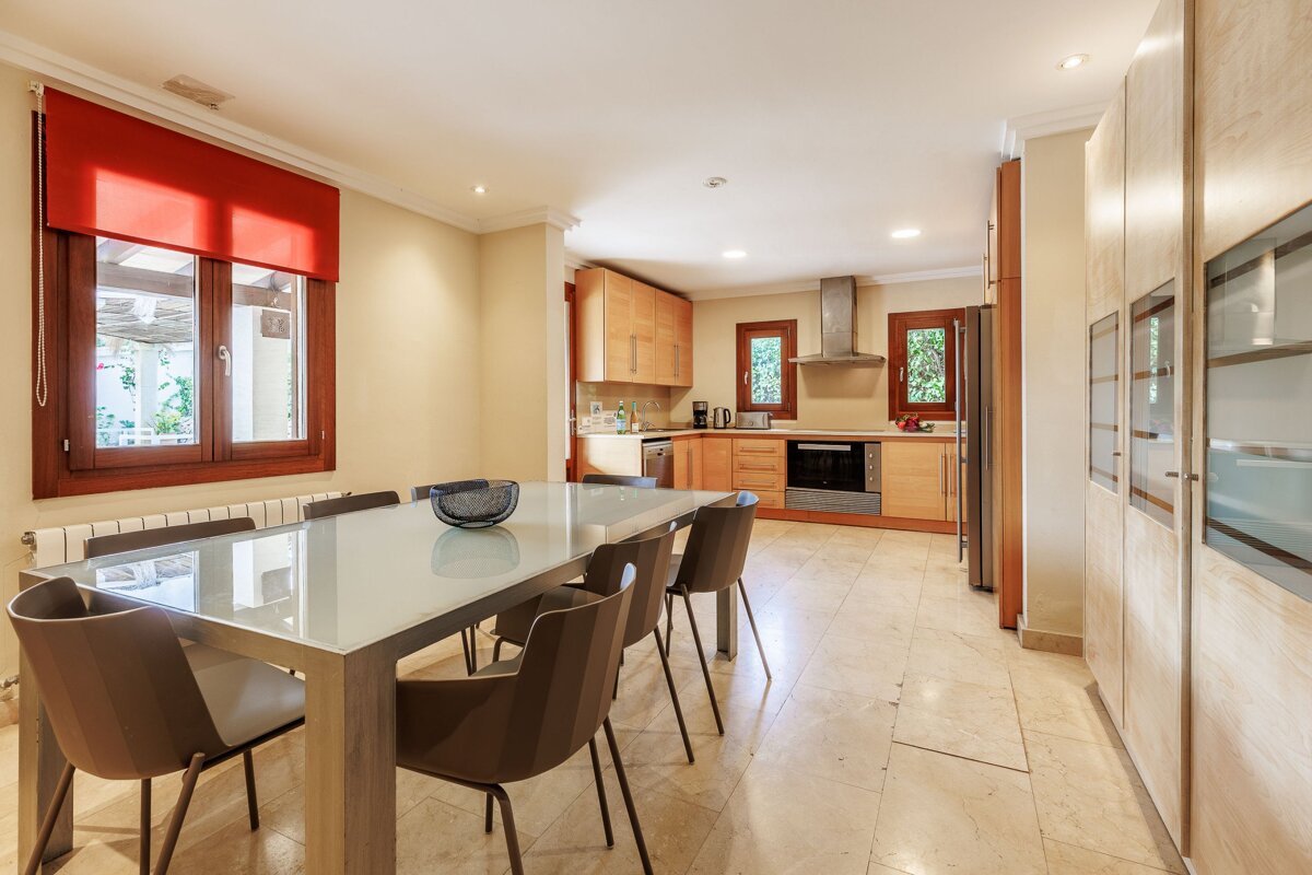 A kitchen with a table and chairs and a window
