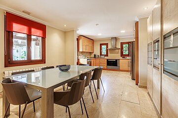 A kitchen with a table and chairs and a window