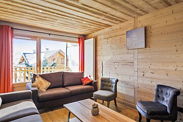 A living room with a couch and two chairs
