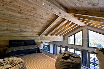 A living room with a couch and bean bag chairs
