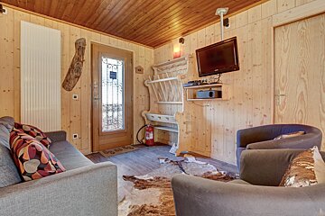 A living room with a couch a chair and a television