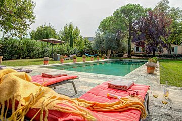 A swimming pool with a hammock in the background