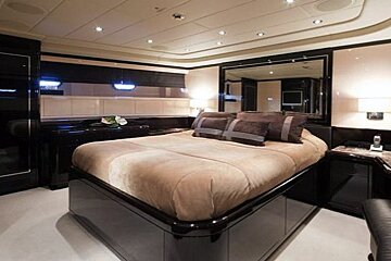 A bedroom with a large bed and a mirror