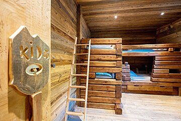 A room with bunk beds and a sign that says kids