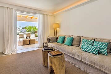 A living room with a couch and two wooden stump tables