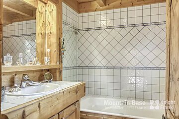 A bathroom with a sink and a bathtub and the words mountain base on the wall