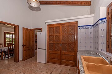A kitchen with a white refrigerator and a sink
