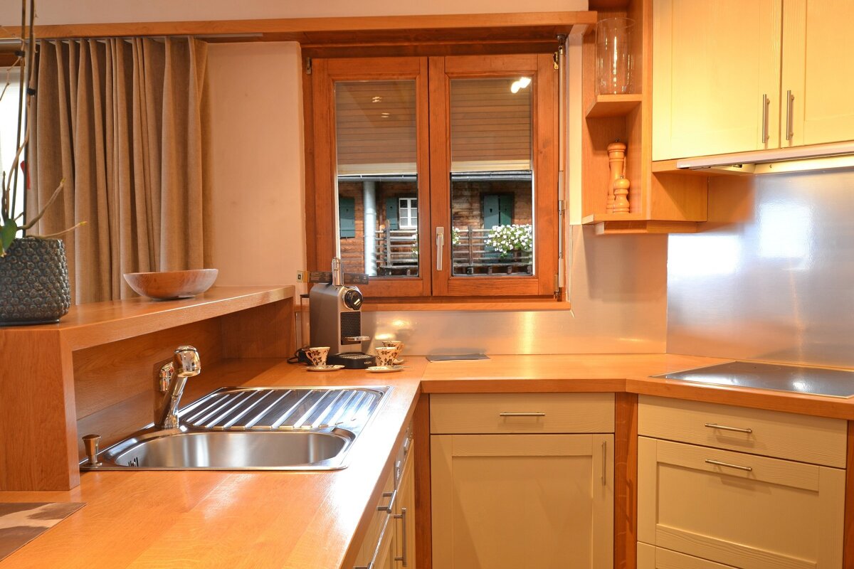 A kitchen with stainless steel appliances and wooden cabinets