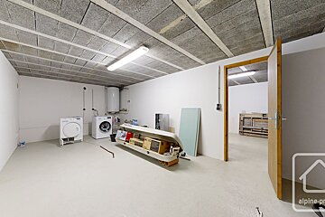A laundry room with a washer and dryer and a sign that says alpine-pro