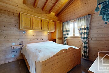 A bedroom with a bed and a sign that says alpine-pro
