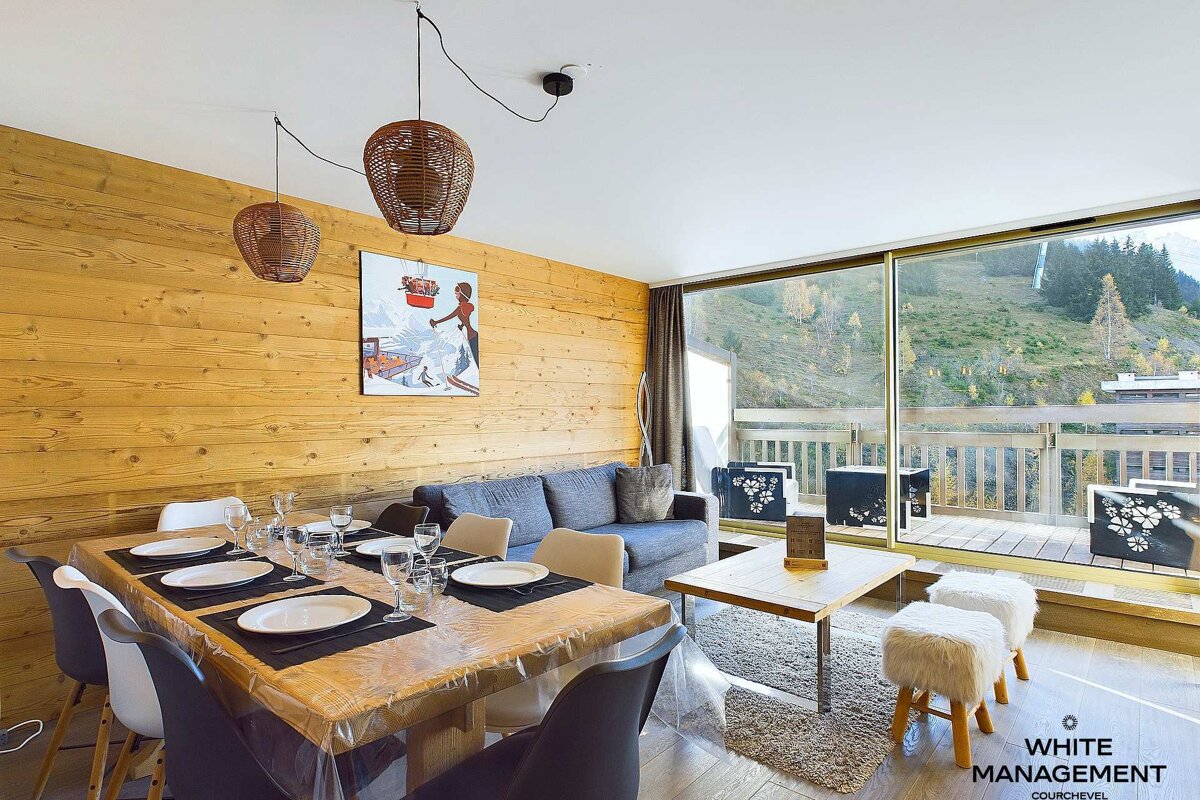 A living room with a dining table and chairs