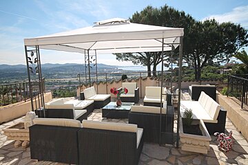 A gazebo with a view of a city and mountains