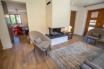 A living room with a fireplace and two chairs