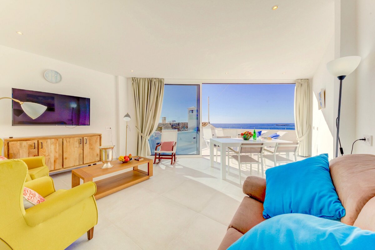A living room with yellow chairs and a flat screen tv