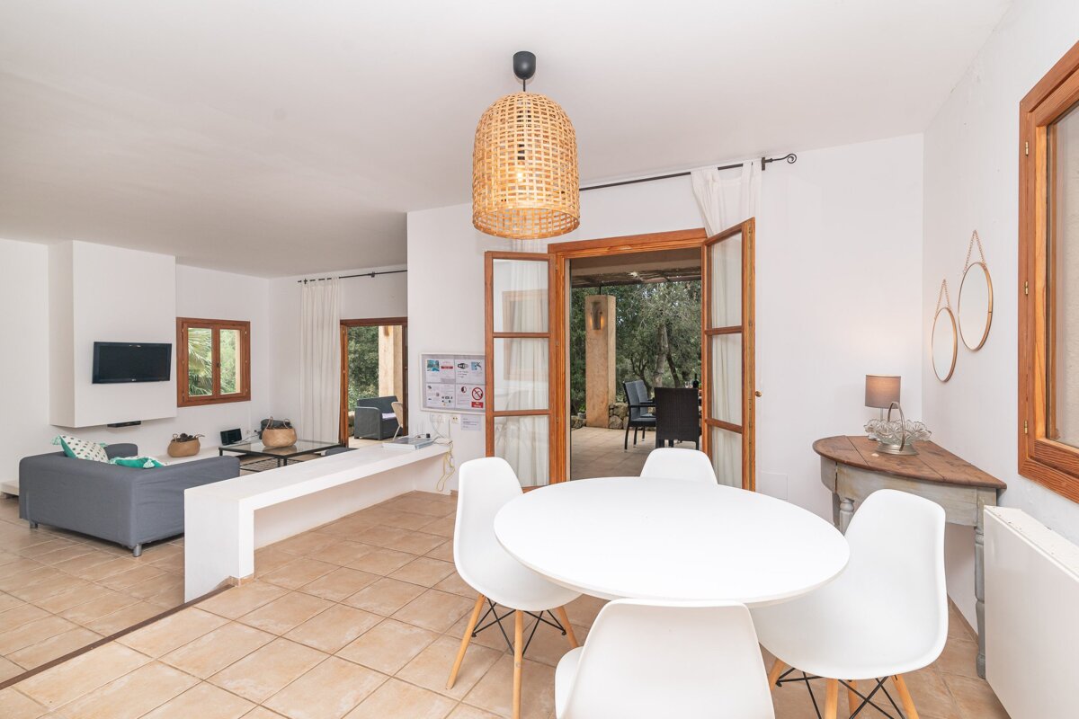 A living room with a white table and chairs
