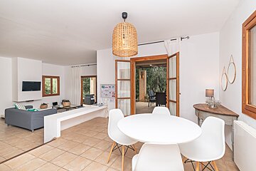 A living room with a white table and chairs