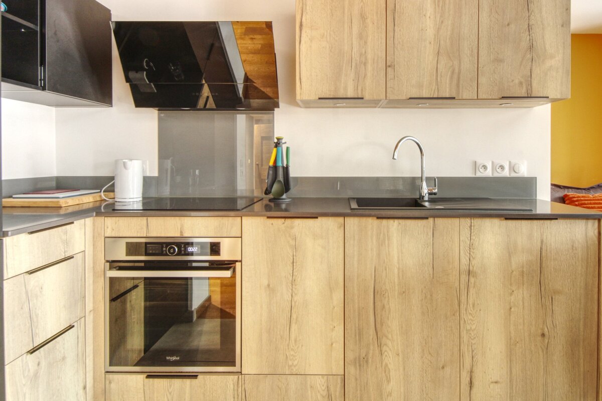 A kitchen with wooden cabinets and a whirlpool oven