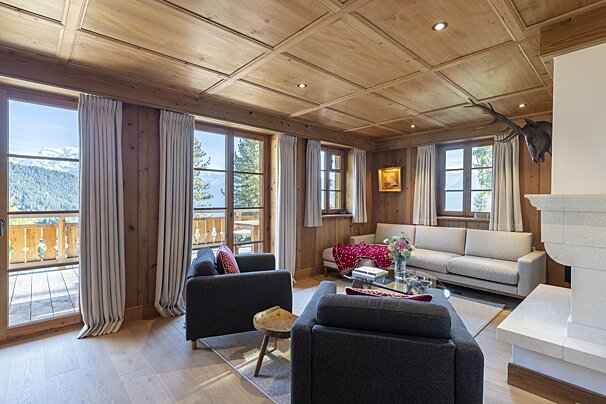 A living room with a couch and two chairs