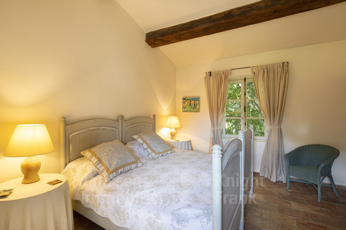 A bedroom with a bed and two lamps and a picture on the wall that says night frank