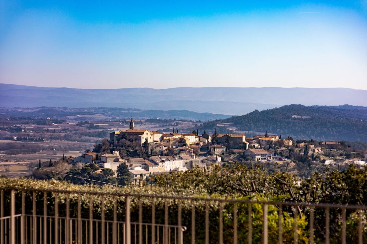 A view of a small town with mountains in the background
