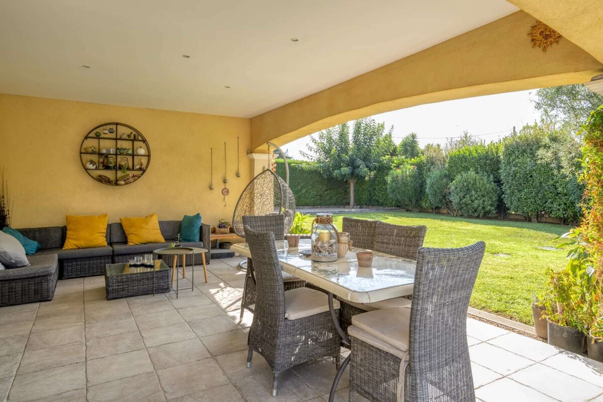 A patio with a table and chairs and a couch