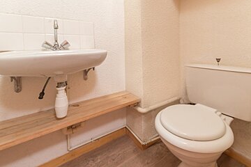 A toilet sits next to a sink in a bathroom