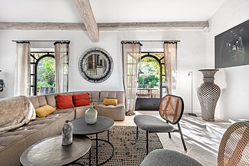 A living room with a couch and a mirror on the wall