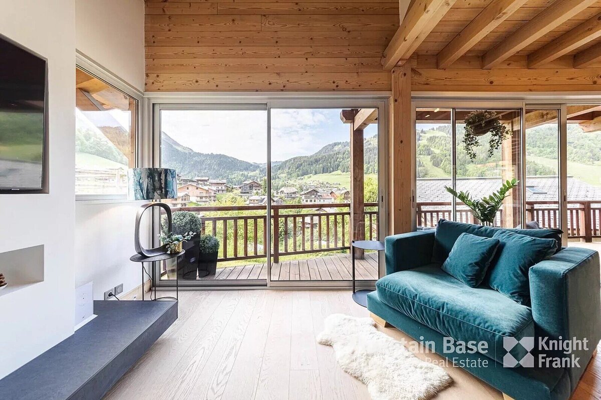 A living room with a blue couch and a knight frank logo