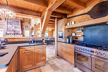 A kitchen with stainless steel appliances and wooden cabinets
