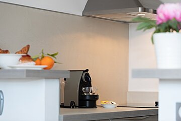 A nespresso machine sits on a kitchen counter